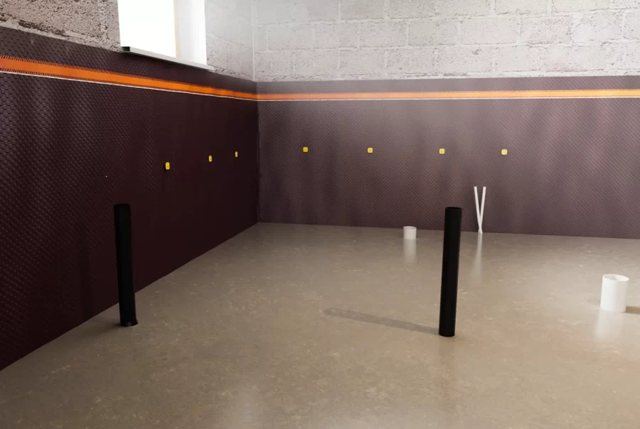 A renovated basement with a smooth concrete floor, standpipes, and waterproofed walls, showcasing the final concrete pour during underpinning.