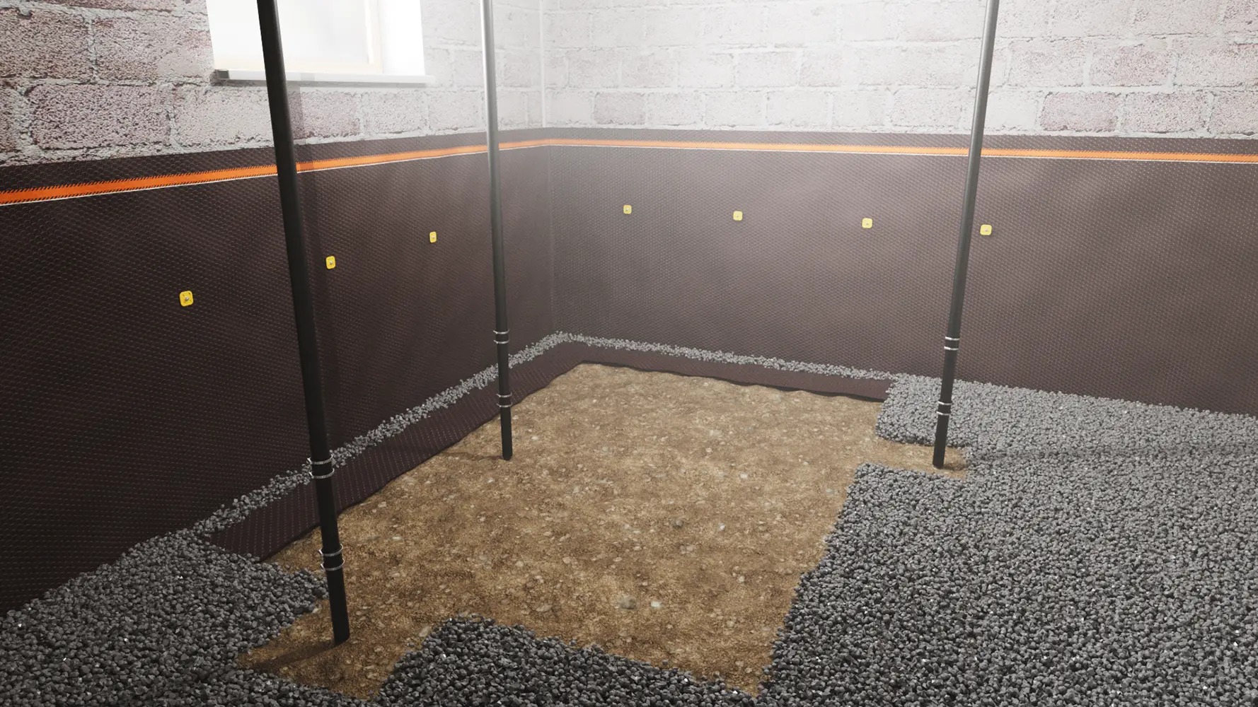 A basement corner with walls covered by a waterproofing membrane and a layer of gravel on the floor, indicating the installation of a waterproofing system during the underpinning process.